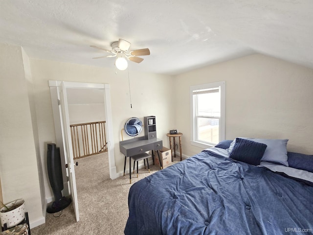 bedroom with ceiling fan, lofted ceiling, and light colored carpet