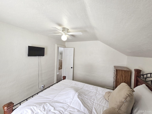 bedroom featuring ceiling fan, a textured ceiling, and vaulted ceiling