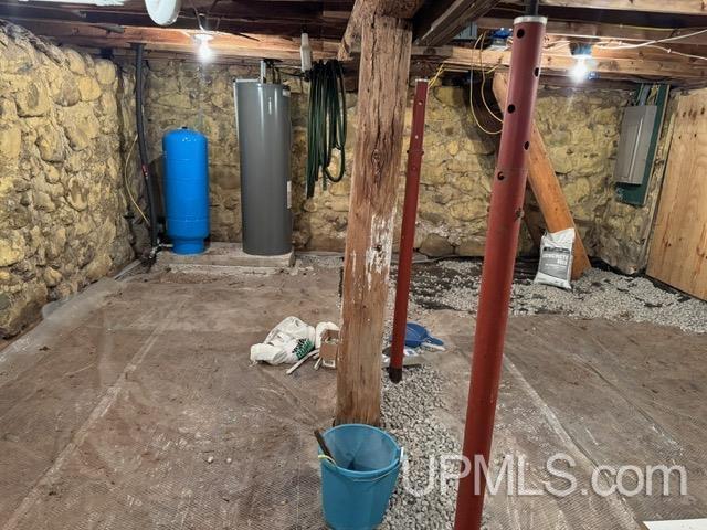 basement with water heater and electric panel