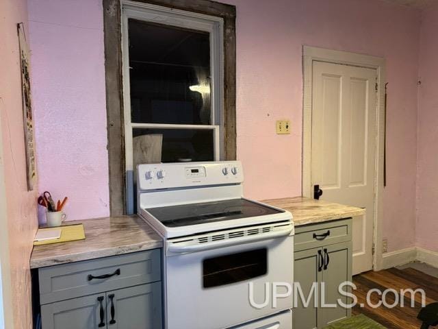 kitchen featuring dark hardwood / wood-style flooring and white range with electric stovetop