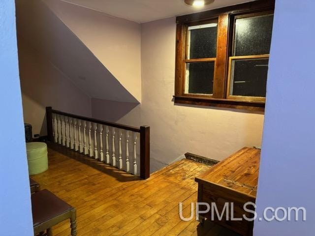 stairway with hardwood / wood-style flooring