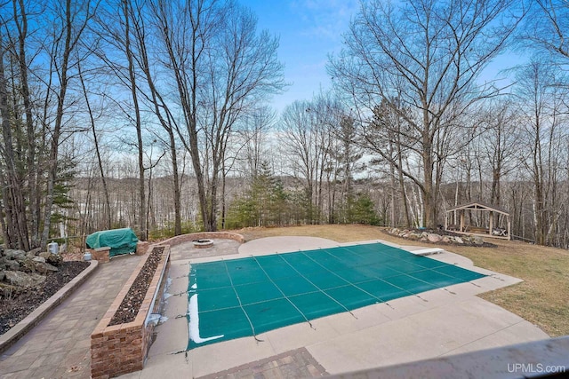 view of pool with a gazebo, a fire pit, and a patio