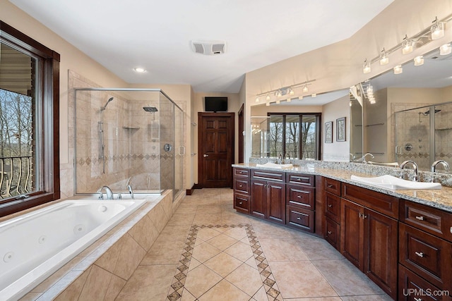 bathroom with tile patterned flooring, vanity, and shower with separate bathtub