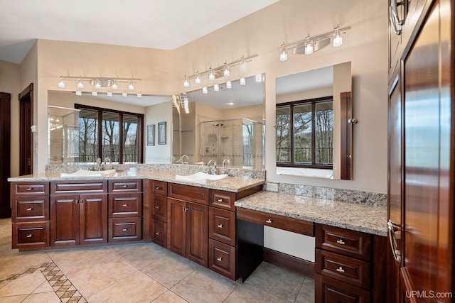 bathroom featuring an enclosed shower, vanity, and tile patterned floors