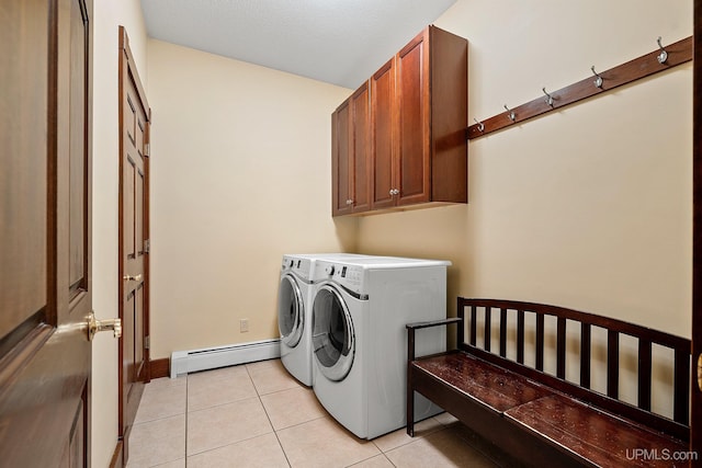 washroom with a baseboard heating unit, cabinets, light tile patterned flooring, and washer and clothes dryer