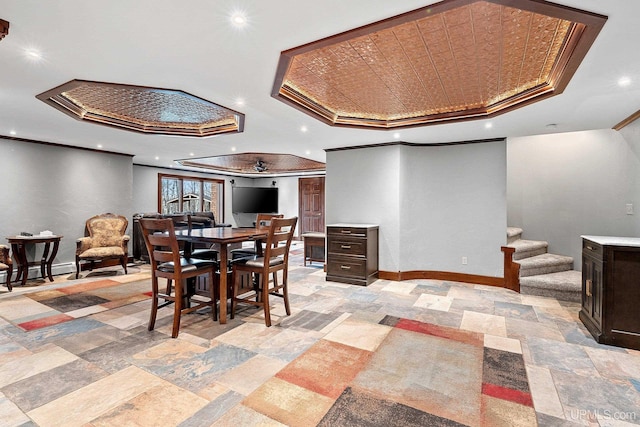 dining space with baseboard heating, crown molding, and a raised ceiling