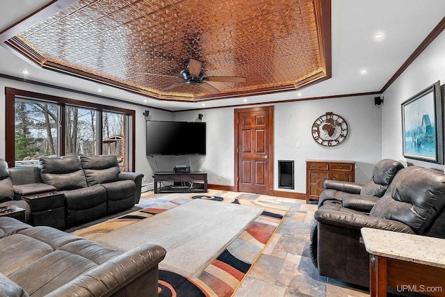 living room featuring ceiling fan, a tray ceiling, and crown molding