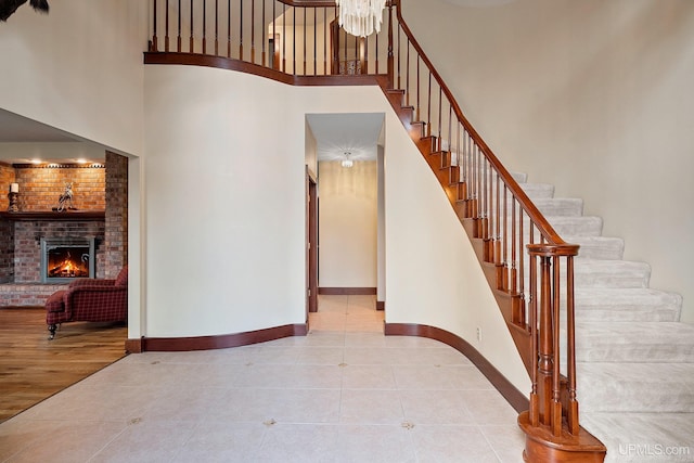 stairs with a fireplace and tile patterned floors