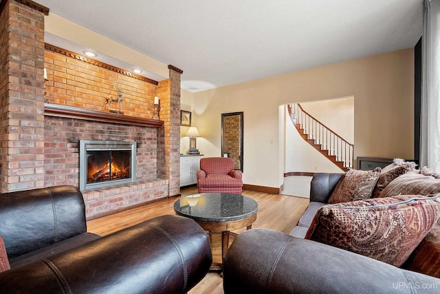 living room with light hardwood / wood-style flooring and a fireplace