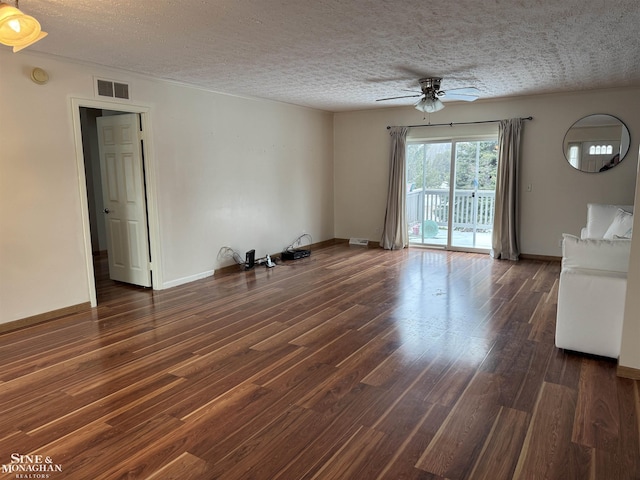 empty room featuring a textured ceiling, ceiling fan, and dark hardwood / wood-style flooring