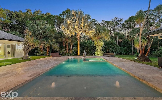 view of pool with a lawn and a patio