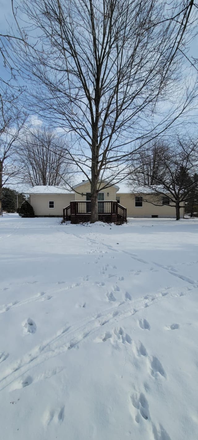 snowy yard with a wooden deck