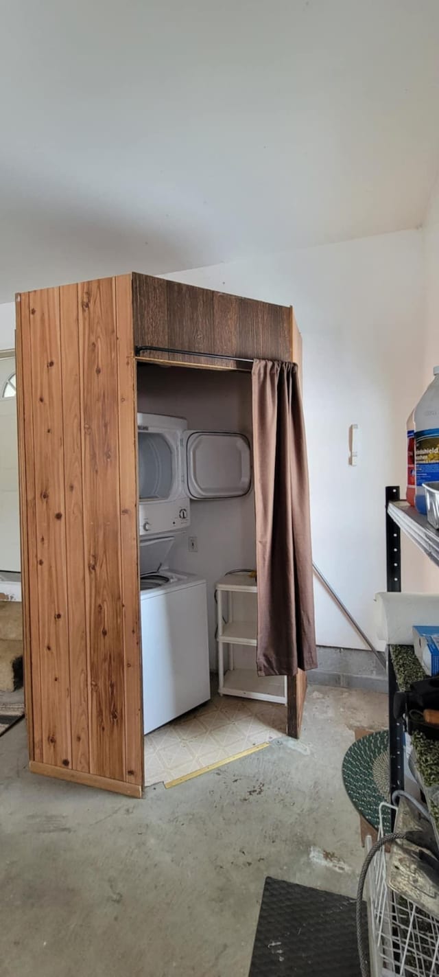 interior space with stacked washer and clothes dryer