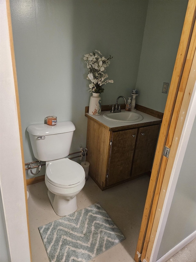 bathroom featuring toilet and vanity