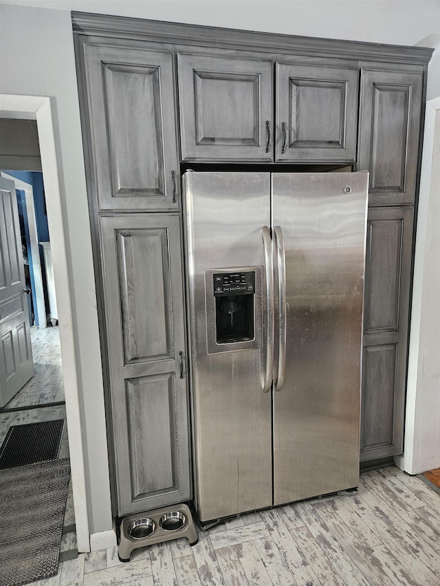 kitchen featuring stainless steel fridge and light wood-type flooring