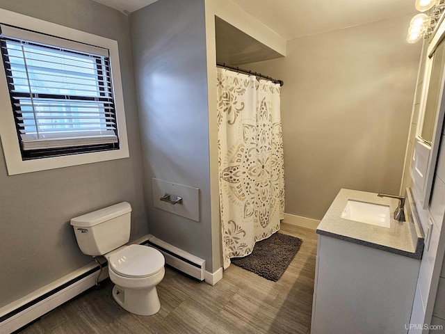 bathroom featuring toilet, vanity, hardwood / wood-style floors, and a baseboard radiator