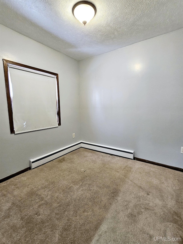 empty room with baseboard heating, a textured ceiling, and carpet flooring