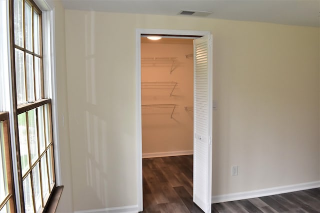 hall with dark wood-type flooring