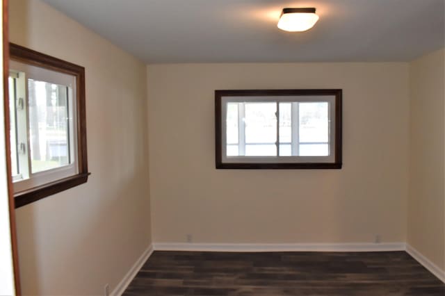 spare room with dark wood-type flooring