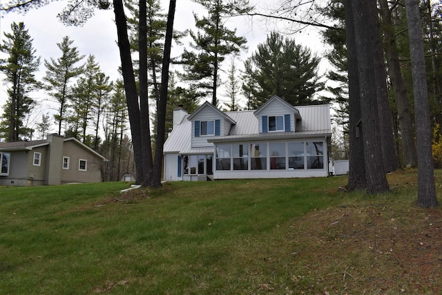 view of front of home featuring a front lawn and a sunroom