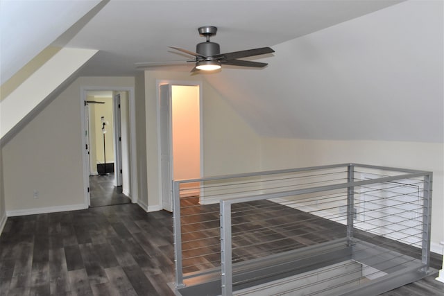 interior space featuring ceiling fan, wood-type flooring, and vaulted ceiling