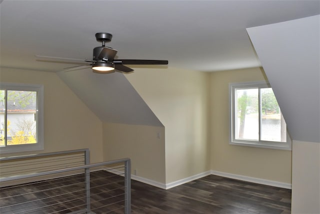 additional living space featuring vaulted ceiling, dark wood-type flooring, and ceiling fan