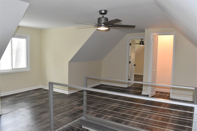 bonus room with ceiling fan, vaulted ceiling, and dark hardwood / wood-style flooring