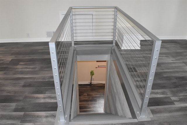 staircase featuring a high ceiling and hardwood / wood-style floors