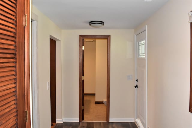 hallway featuring dark hardwood / wood-style flooring