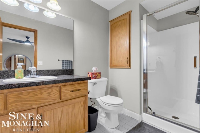 bathroom featuring toilet, a shower with shower door, ceiling fan, tile patterned floors, and vanity