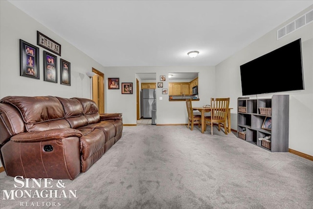 living room featuring light carpet