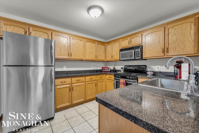 kitchen with light tile patterned floors, appliances with stainless steel finishes, and sink