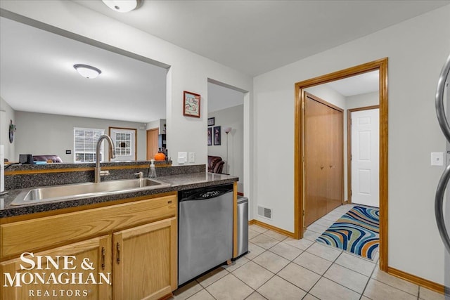 kitchen featuring sink, light tile patterned floors, and dishwasher