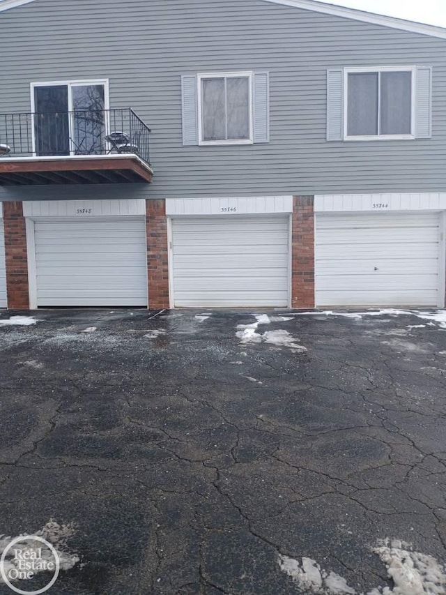 exterior space featuring a garage and a balcony