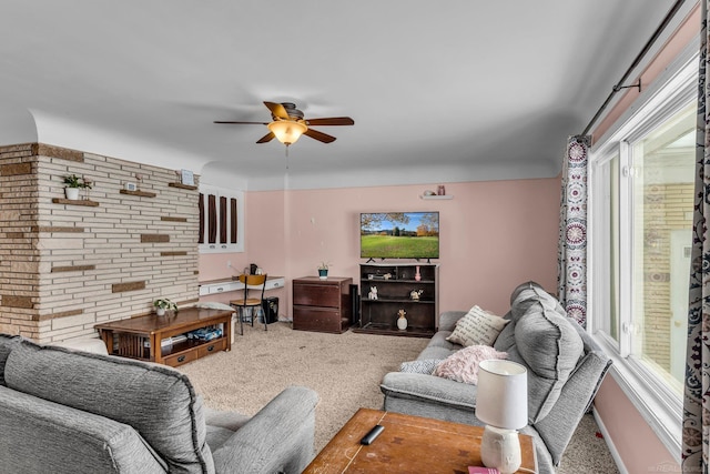 carpeted living room with ceiling fan