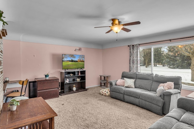 living room featuring ceiling fan, carpet floors, and a healthy amount of sunlight