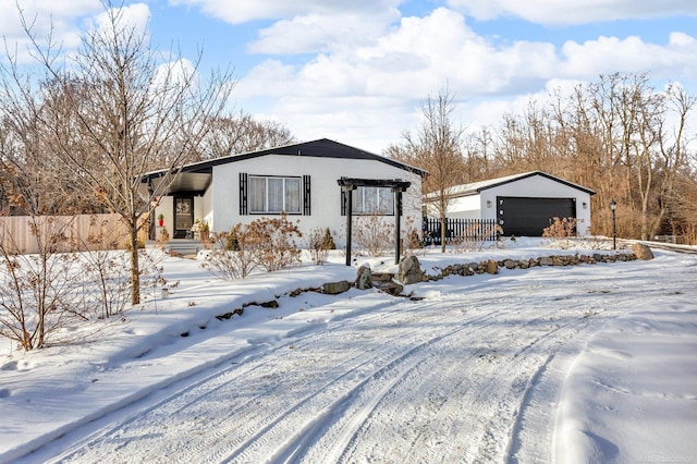 snow covered structure featuring a garage