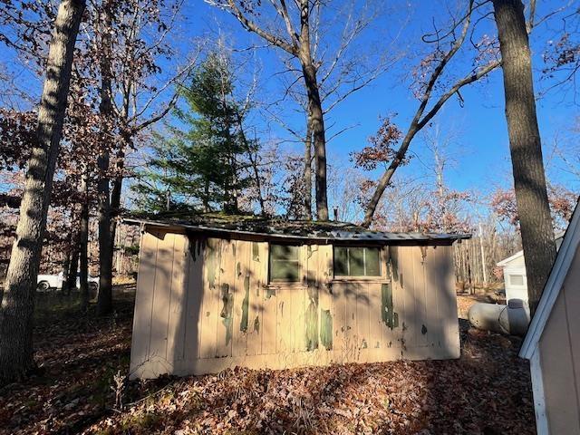 view of home's exterior featuring a storage unit