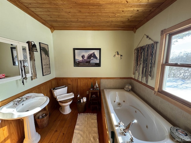 bathroom with toilet, wood ceiling, tiled tub, and wood-type flooring