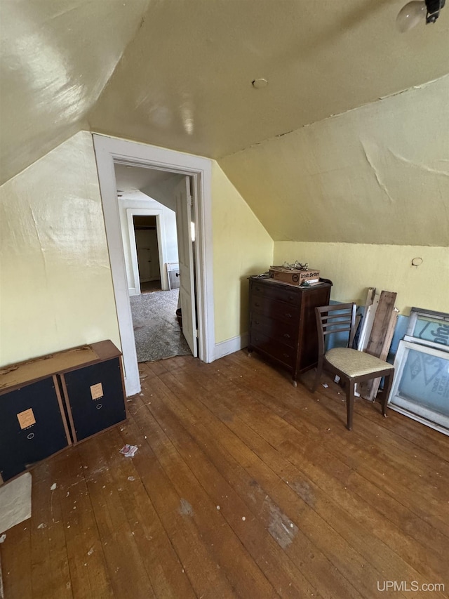 bonus room featuring vaulted ceiling and dark hardwood / wood-style floors