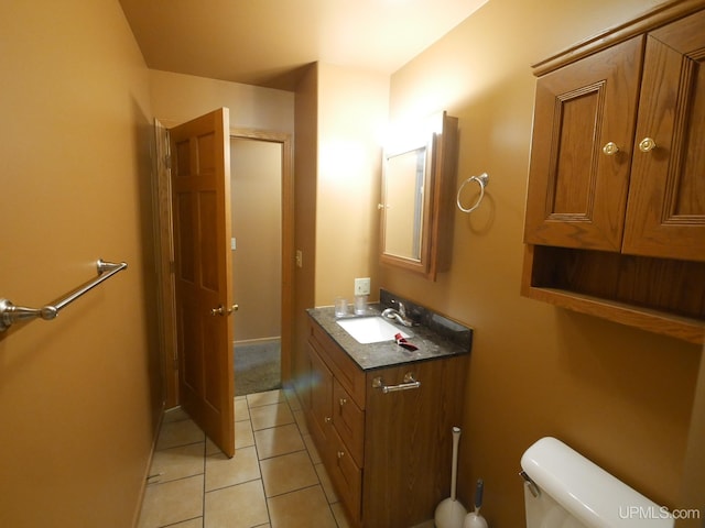 bathroom featuring toilet, tile patterned flooring, and vanity