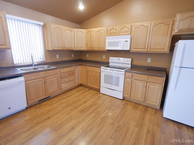 kitchen featuring light brown cabinets, white appliances, light wood-type flooring, vaulted ceiling, and sink