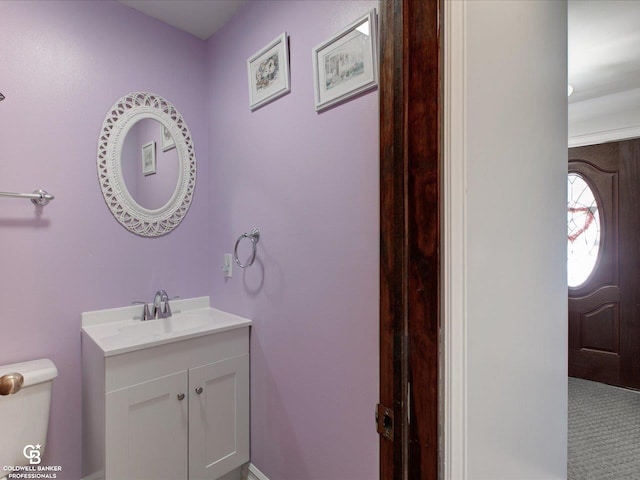 bathroom featuring toilet and vanity