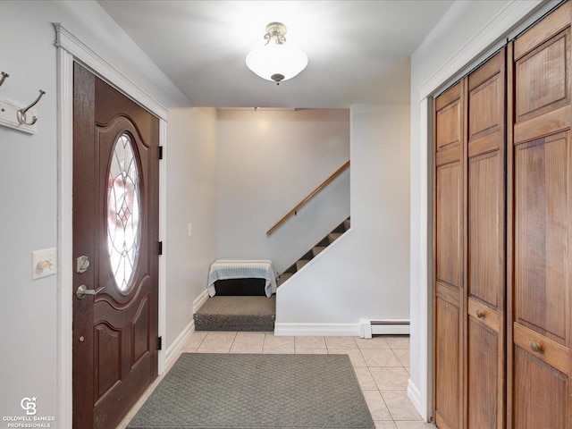 tiled foyer with a baseboard heating unit