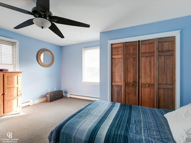 bedroom featuring ceiling fan, carpet floors, multiple windows, and a baseboard radiator