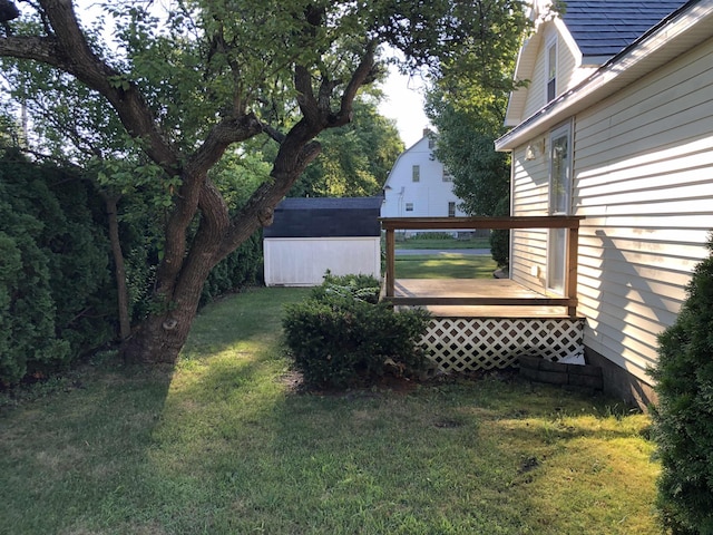 view of yard with a deck and a shed