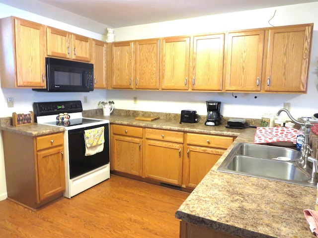 kitchen with electric range, sink, and light hardwood / wood-style floors