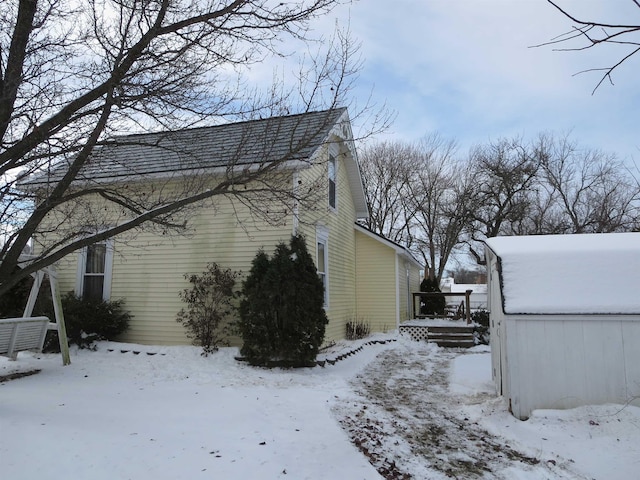 view of snow covered exterior featuring a deck