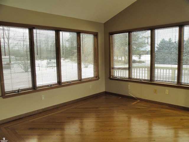 unfurnished sunroom featuring a healthy amount of sunlight and vaulted ceiling