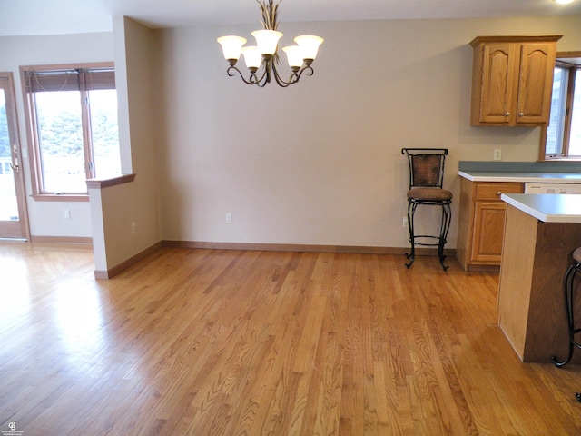 unfurnished dining area with light hardwood / wood-style flooring and a chandelier